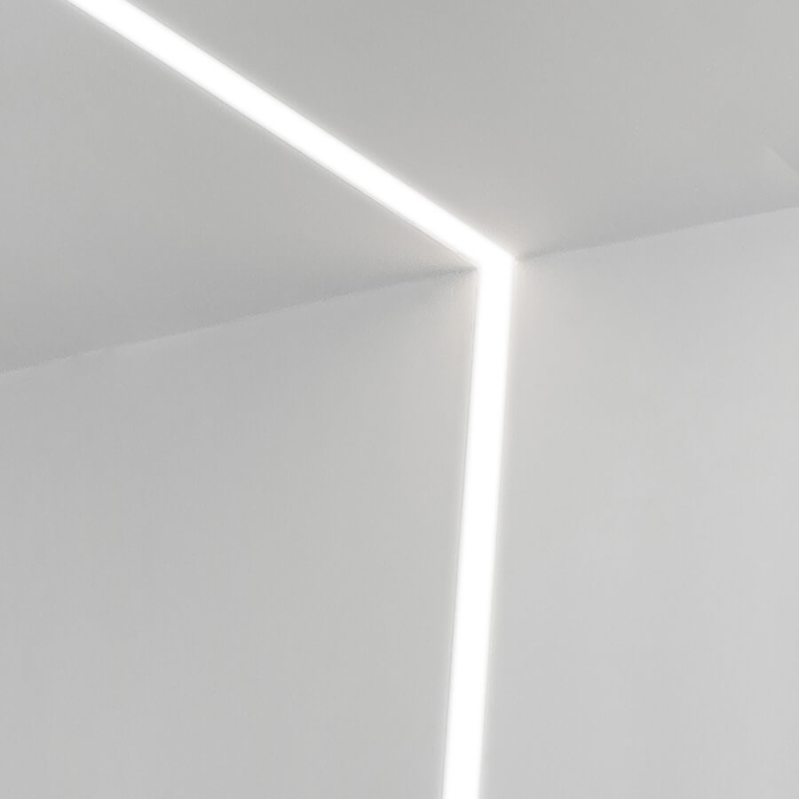 thin recessed linear light along the ceiling and wall