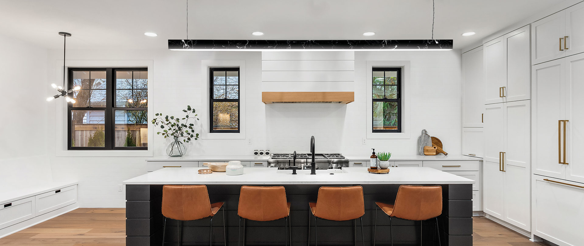 Black marble texture pendant light hanging above a white kitchen countertop